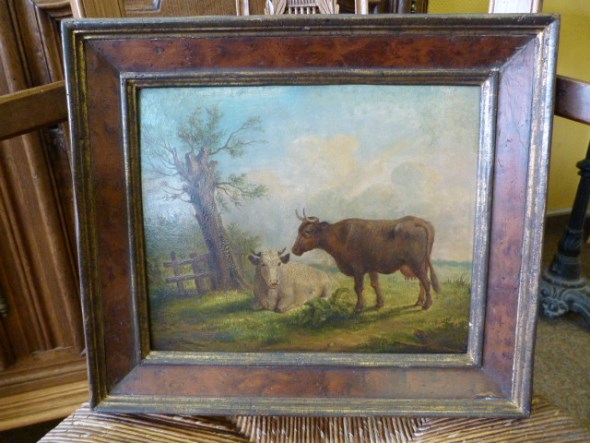 A panel painting of two cows