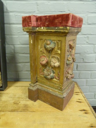 A wooden carved stand